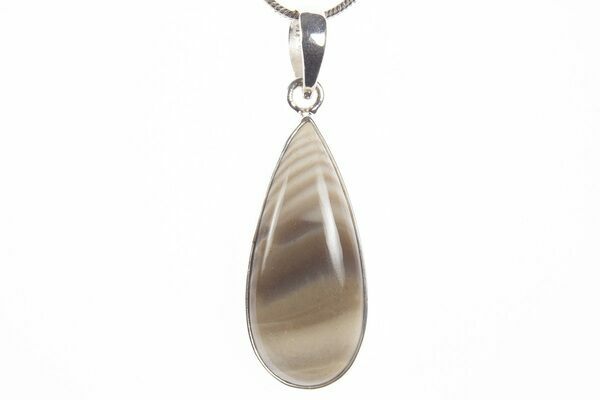 A striped flint pendant showing its use in modern jewelry